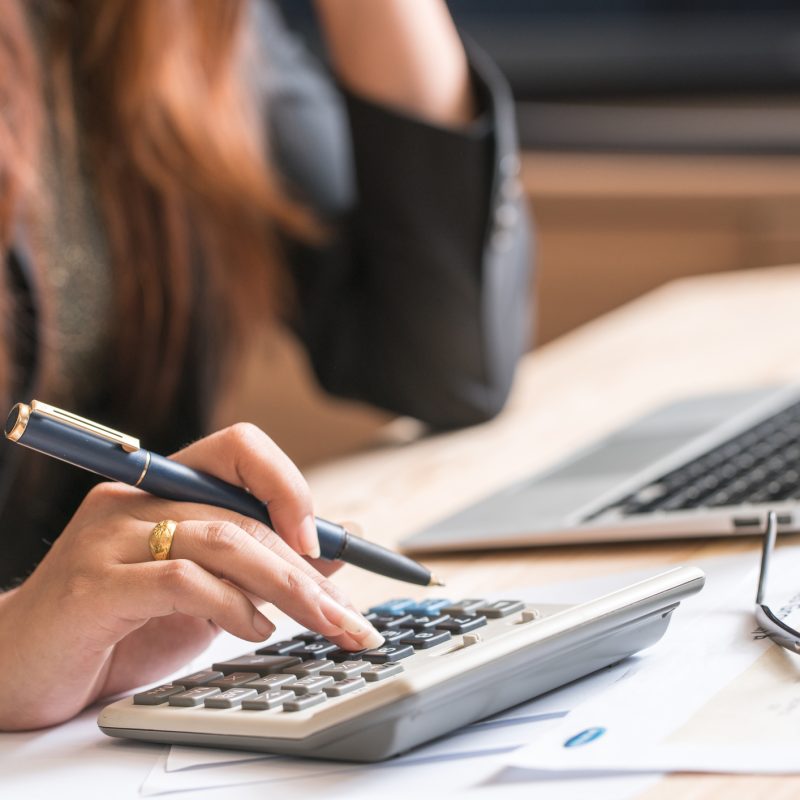 Close Up Of Female Accountant Or Banker Making Calculations. Sav