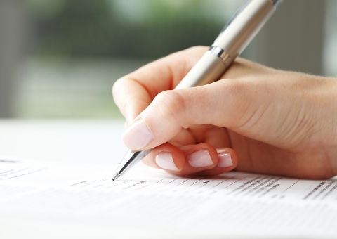 Businesswoman Writing On A Form Stock Image 0
